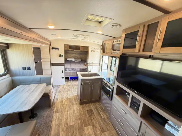 Explore this modern RV rental! Features include a comfy dinette, complete kitchen, TV, and a private bedroom area.. Crossroads RV Sunset Trail Super Lite 2021
