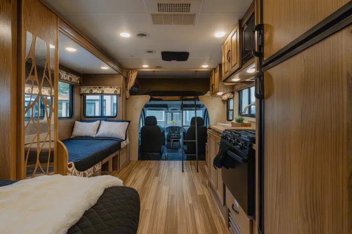 Explore in comfort: this rv rental features a cozy bed, full kitchen, and front cabin views for your journey.. Coachman Prism 2200 LE 2017