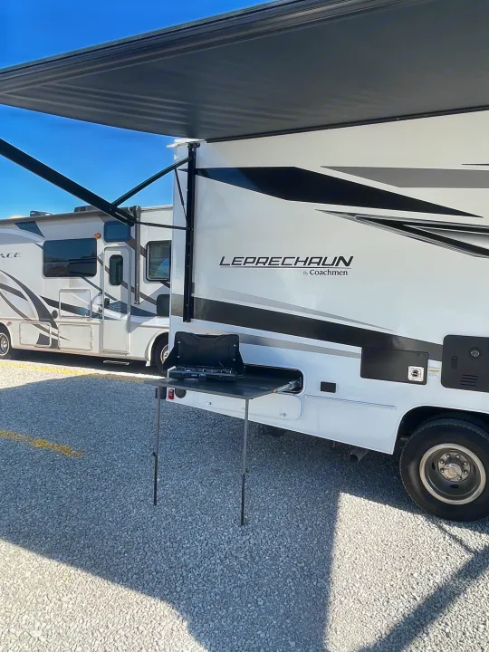 This white Coachmen Leprechaun RV rental features an extended awning and an outdoor kitchen, perfect for your next adventure.. Forest River Coachmen Leprechaun 2025