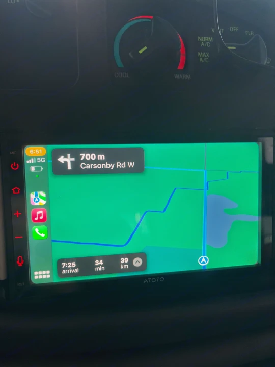RV rental trip navigation on an ATOTO screen: next turn onto Carsonby Rd W, 39km to go. Climate control visible above.. Gulf Stream Ultra 1998