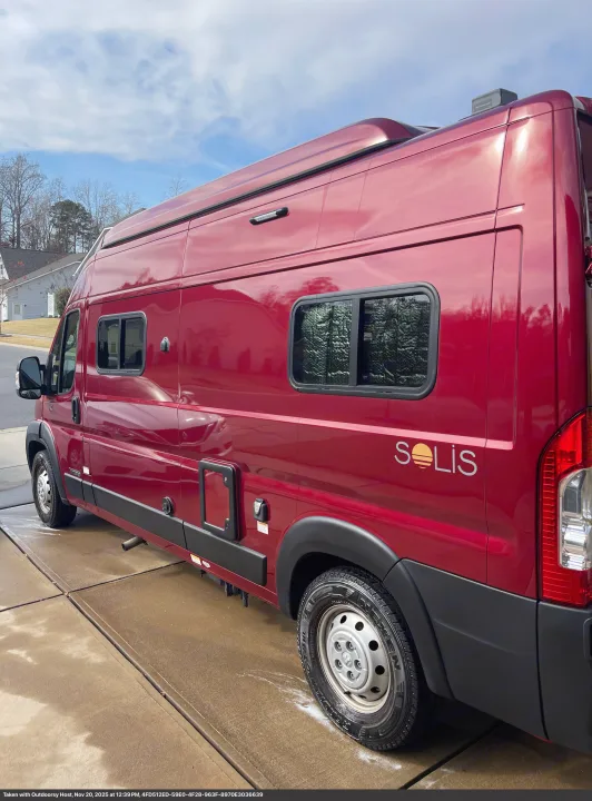Ready for adventure: a gleaming red Winnebago Solis camper van, perfect for your next RV rental. Parked on concrete.. Winnebago Solis 2023