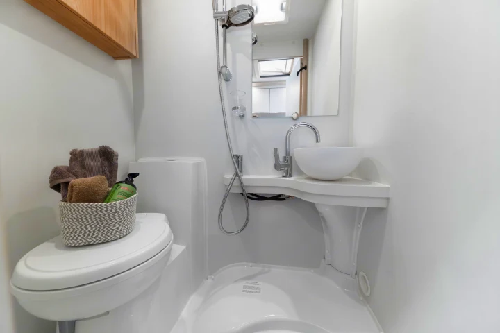 Efficient RV rental bathroom featuring a modern toilet, vessel sink, and shower in a bright, clean space.. Elddis Whirlwind GT 196 2026