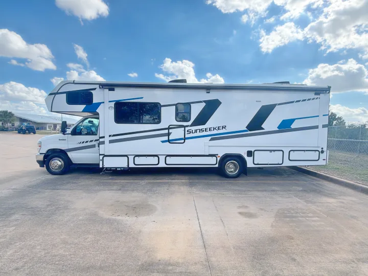 This white Sunseeker rv rental, a Class C motorhome, is parked outdoors, ready for your next travel adventure.. Forest River Sunseeker Classic 2025