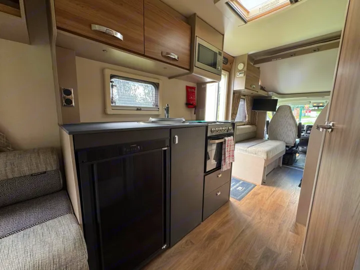 This RV rental features a well-equipped kitchen with fridge, sink, oven, and comfortable living/dining space for your travels.. Swift Edge 486 2024