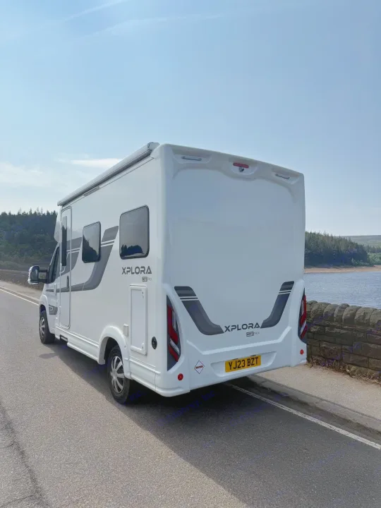 White Xplora Mototrek RV rental parked by a scenic lake. Perfect for your next motorhome adventure or road trip!. Moto-Trek Xplora FDB 2025