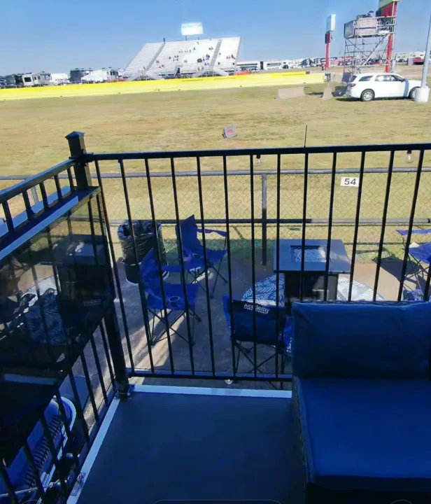 Enjoy the race day view from your RV rental's spacious deck! Features cozy seating and a fire pit overlooking the track.. Keystone RV Raptor Toy Hauler 2012