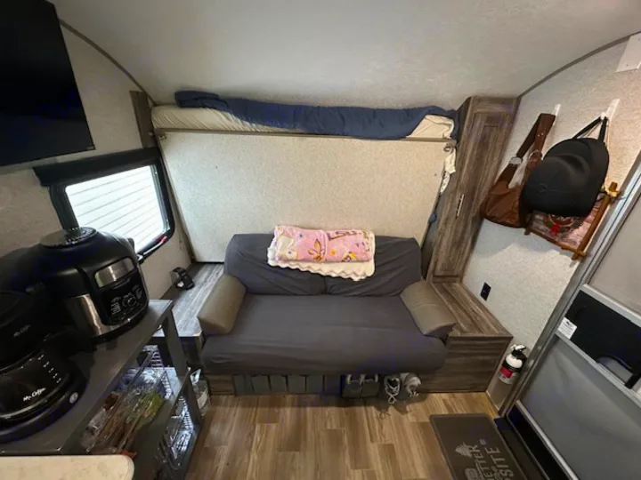 Compact rv rental interior with a bunk bed, sofa, kitchenette, and essentials. Perfect for functional living space.. Forest River Salem FSX PLATINUM 2020