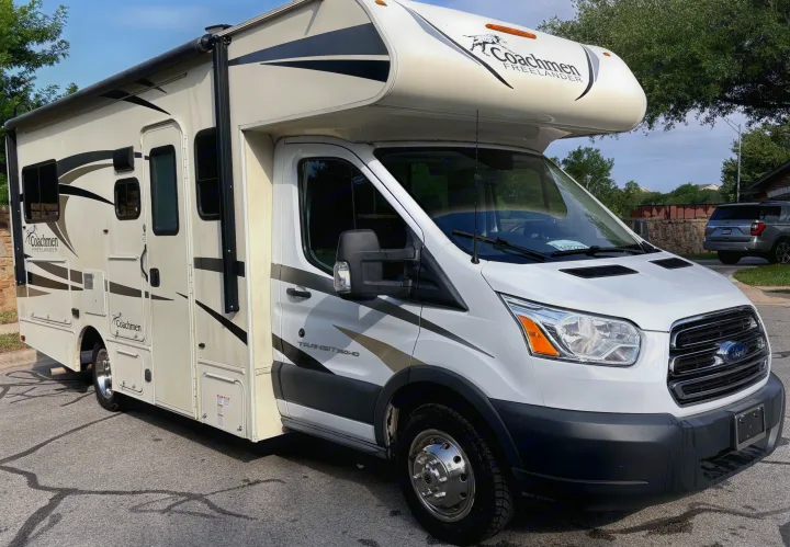 White Coachmen Freelander Class C RV rental with striking graphics, parked on a sunny day. Ideal motorhome for your next adventure.. Forest River Coachmen Freelander Micro 2018