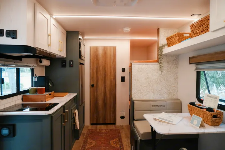 Cozy and modern rv rental interior featuring a full kitchen, dining area, and comfortable bunk beds for guests.. Heartland RVs Eddie Bauer 2025
