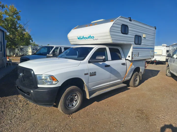 White Dodge Ram truck with a "Whitewater" camper, a perfect rv rental for your next adventure.. Glacier Campers Truck Camper 2016