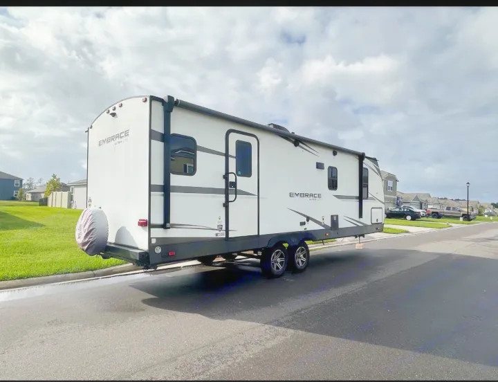 RV rental: An Embrace Ultra Lite travel trailer parked on a residential street, perfect for your next camping adventure.. Cruiser RV Embrace Ultra Lite 2022