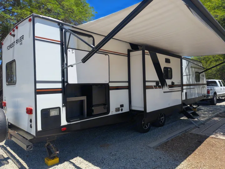 This white Forest River Vibe rv rental features an extended awning, a side slide-out, and an open outdoor kitchen.. Forest River Vibe 2020