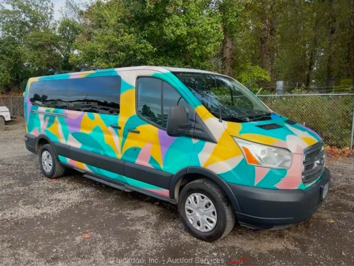 Vibrant, abstract-painted Ford Transit van. This unique RV rental, parked on gravel, is perfect for adventure travel.. Ford Transit 2017