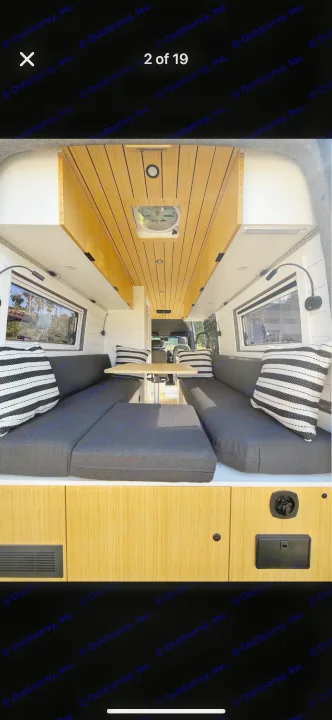 Modern RV rental interior: bamboo ceiling, cozy seating, and dining area. Experience comfort on wheels.. Mercedes Sprinter 2022