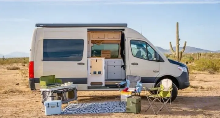 Explore the desert! This RV rental offers a fully equipped camper van with outdoor cooking and seating setup ready for adventure.. VanCraft VanCraft Class B 2022
