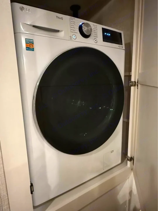 LG ThinQ front-load washing machine in a compact RV rental space. Keeps clothes clean during your travels.. Jayco Eagle 2024