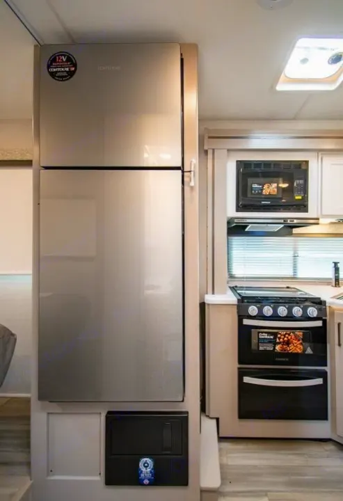 RV rental interior: Kitchen area features a stainless steel refrigerator, microwave, and oven for convenient travel.. Four Winds 28z 2027