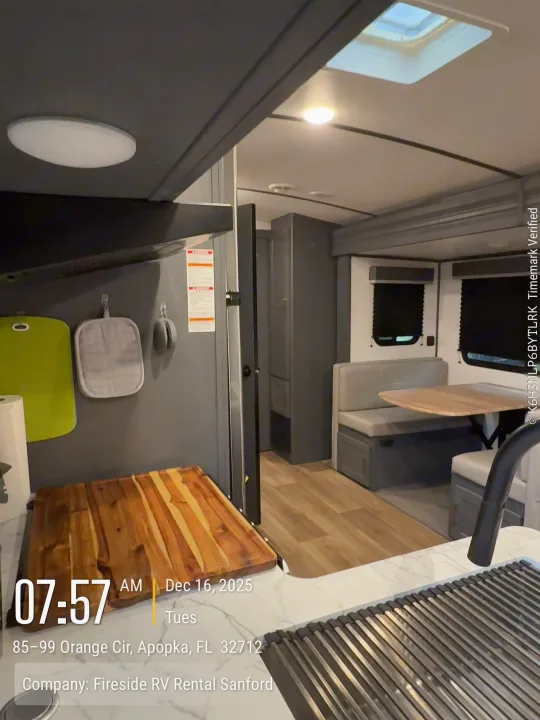 Spacious, modern RV rental interior with a kitchen counter, sink, and a comfortable dinette area for meals.. Keystone Bullet 2022