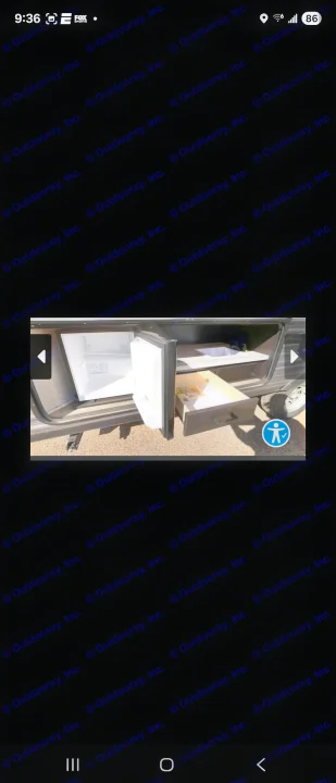 Open RV rental compartment revealing an outdoor kitchen with mini-fridge, sink, and pull-out drawer for convenience.. Jayco Jay Flight SLX 2022