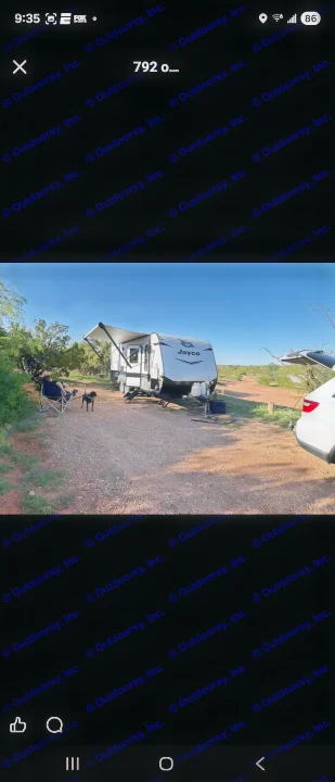 Serene RV rental campsite with a Jayco travel trailer, person, and dog enjoying the sunny outdoors.. Jayco Jay Flight SLX 2022