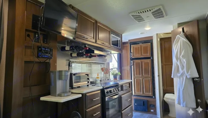 Cozy RV rental interior with full kitchen, entertainment system, and compact bathroom for convenient travel.. Forest River Rockwood Mini Lite 2020