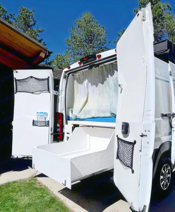 This RV rental shows a custom camper van with a large pull-out storage drawer from the rear, perfect for outdoor gear.. Ram Promaster 2500 2019