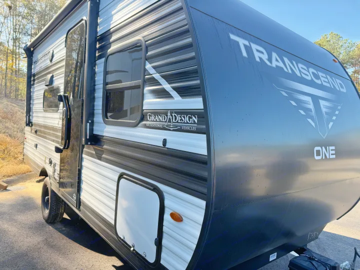 Grand Design Transcend RV rental: a modern travel trailer with a distinctive black and white exterior, parked outdoors.. Grand Design Transcend One 2025