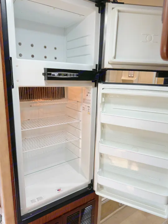 Empty Norcold refrigerator interior, ready for your food on an RV rental adventure.. Jayco Melbourne 2012