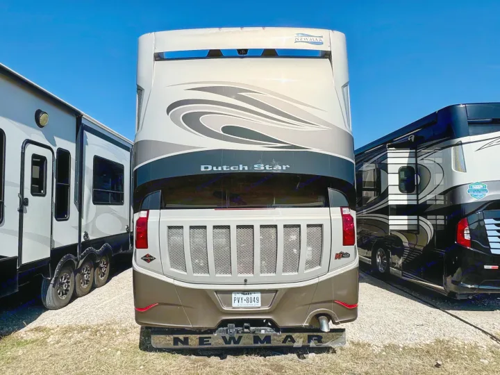 Rear view of a grey Newmar Dutch Star motorhome (Texas plate PVY-8049), parked outdoors, ideal for rv rental.. Dutch Star Dutch Star Motorhome 2017