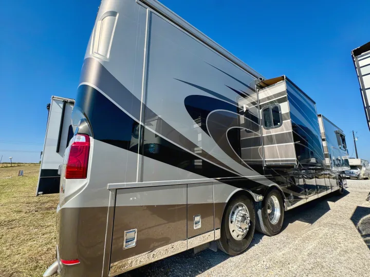 Sleek silver & black luxury RV rental with extended slide-outs, parked outdoors under a clear blue sky.. Dutch Star Dutch Star Motorhome 2017
