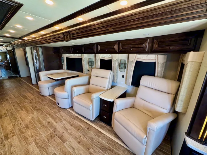 Spacious RV rental interior featuring plush recliners, a dining booth, and a full kitchen, ideal for comfortable travel.. Dutch Star Dutch Star Motorhome 2017