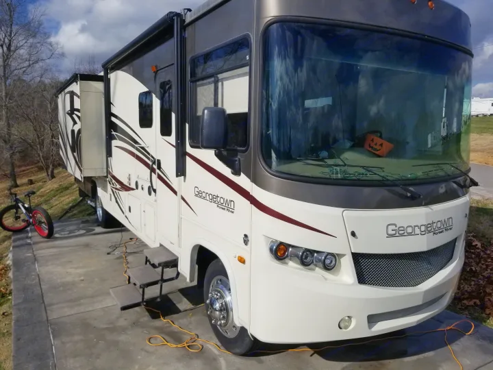 Georgetown Forest River rv rental motorhome with extended slide-out and a fun pumpkin inside, parked at a scenic site.. Georgetown Georgetown Motorhome 2016