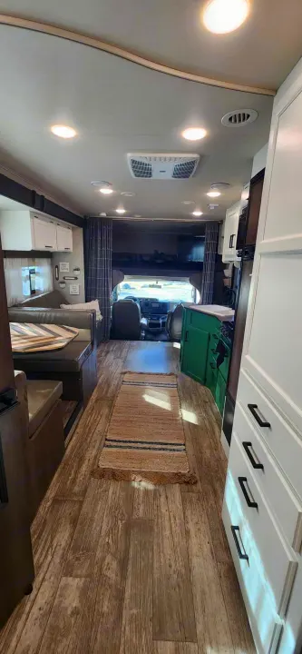 Spacious RV rental interior featuring a living area, kitchen, and overhead bunk bed, ready for travel adventures.. Jayco Redhawk 2017