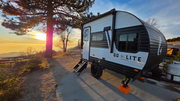 Golden hour camping with our rv rental, a Go Lite Skybreaker travel trailer, parked at a scenic site overlooking a stunning sunset.. Wayfinder RV Go Lite 2025