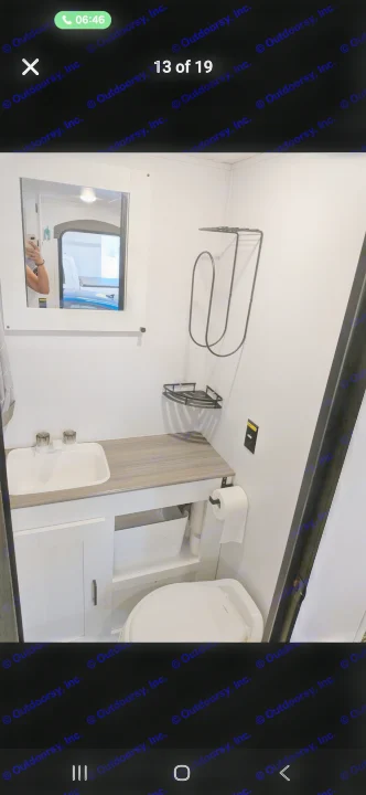 Compact and clean RV rental bathroom, featuring a sink, toilet, mirror, and shelves. Ideal for travelers.. Keystone RV Hideout 2022