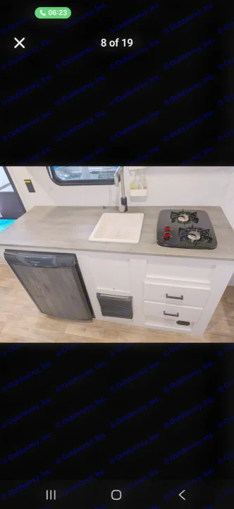 Explore this RV rental kitchen! Features include a sink, two-burner stove, compact refrigerator, and handy storage drawers.. Keystone RV Hideout 2022