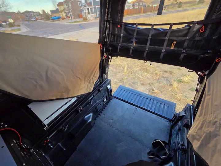 Spacious truck bed camper interior, ready for adventure. Perfect for an RV rental getaway with views of residential streets.. Toyota Tacoma 2018