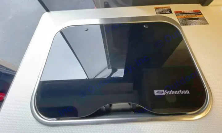 Modern Suburban cooktop cover in an RV rental kitchen. The sleek, dark glass adds counter space when burners are off.. Winnebago Solis 2025