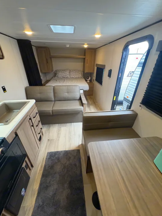 Well-appointed rv rental interior showcasing a full kitchen, dinette, sofa, and bed area for ultimate comfort.. Keystone RV Coleman 2025