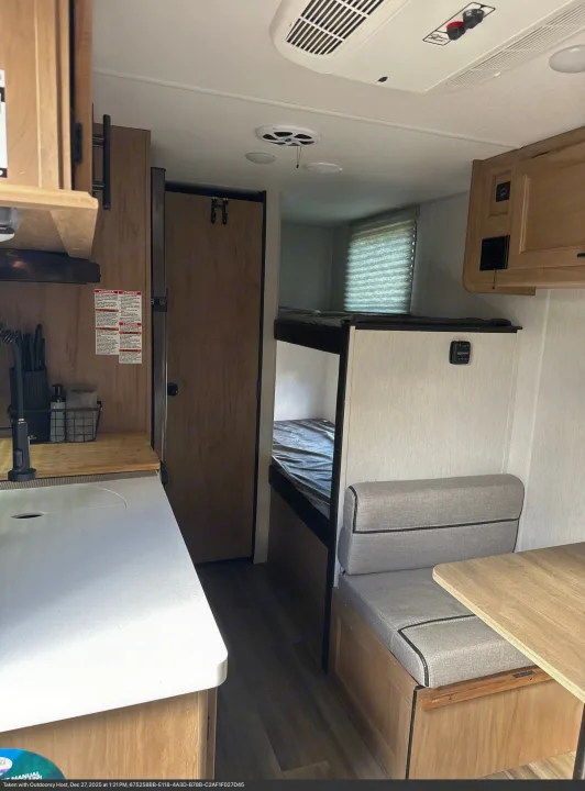 Explore this rv rental's compact interior, featuring a functional kitchen area, cozy bunk beds, and a comfortable dinette.. Forest River Cherokee Wolf Pup 2023
