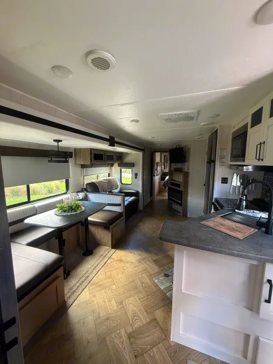 Spacious RV rental interior with modern dinette, kitchen, and living area. Perfect for a cozy getaway.. Forest River Palomino Puma 2022