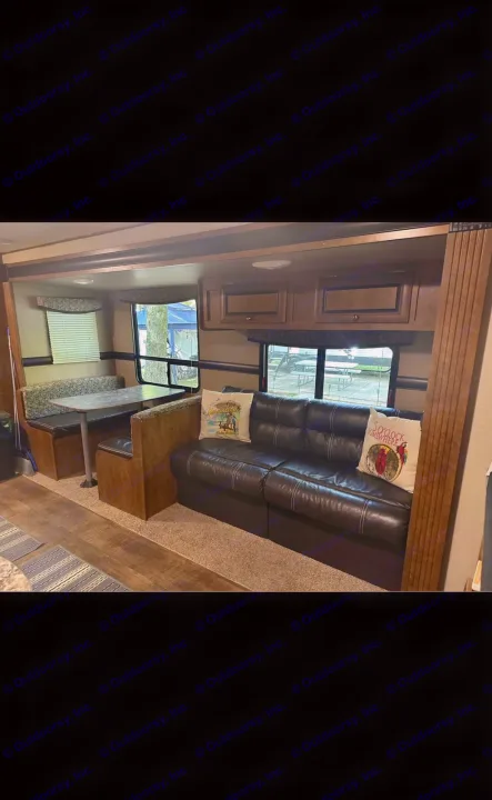 RV rental interior featuring a cozy dinette and a dark sofa with decorative pillows, ready for your next adventure.. Crossroads RV Z-1 2017