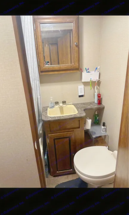 This RV rental's compact bathroom features a sink, toilet, mirror, and toiletries for a convenient travel experience.. Crossroads RV Z-1 2017