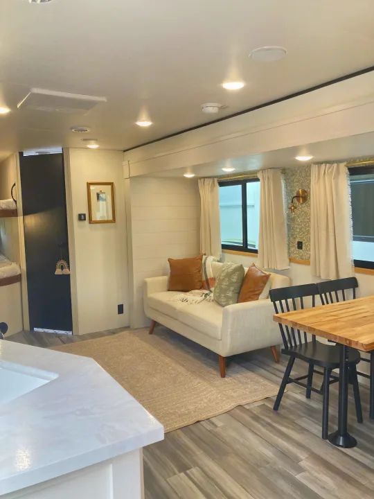 Cozy modern RV rental interior with living, dining, and kitchen areas, light decor, and wooden accents.. Jayco Jay Flight SLX 2025