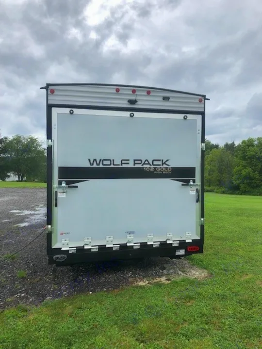 RV rental: Rear view of a Wolf Pack toy hauler, featuring its large ramp door on a cloudy day.. Forest River Cherokee Wolf Pack 2021