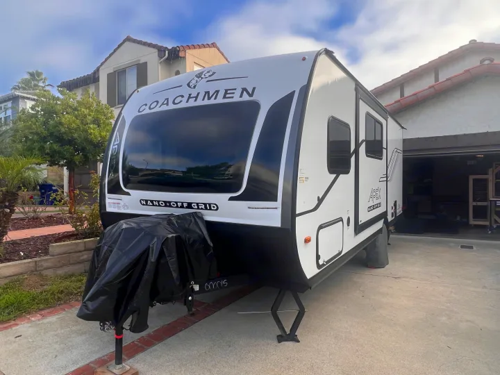 A white Coachmen Nano Off-Grid travel trailer, ideal for an RV rental, parked in a sunny driveway.. Coachmen Apex Nano 194BHS 2026