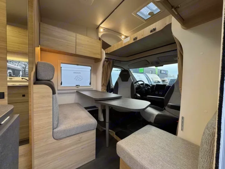 Spacious RV rental interior: a bright, modern dining area with light wood, gray seating, and the motorhome's cabin visible.. CHALLENGER C194 START EDITION 2026