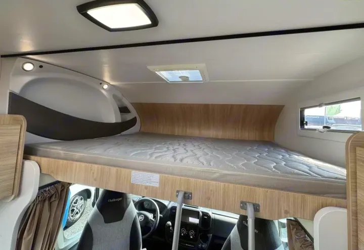 Overhead bed in an RV rental, offering a cozy sleeping area above the driver's cabin, perfect for camper adventures.. CHALLENGER C194 START EDITION 2026