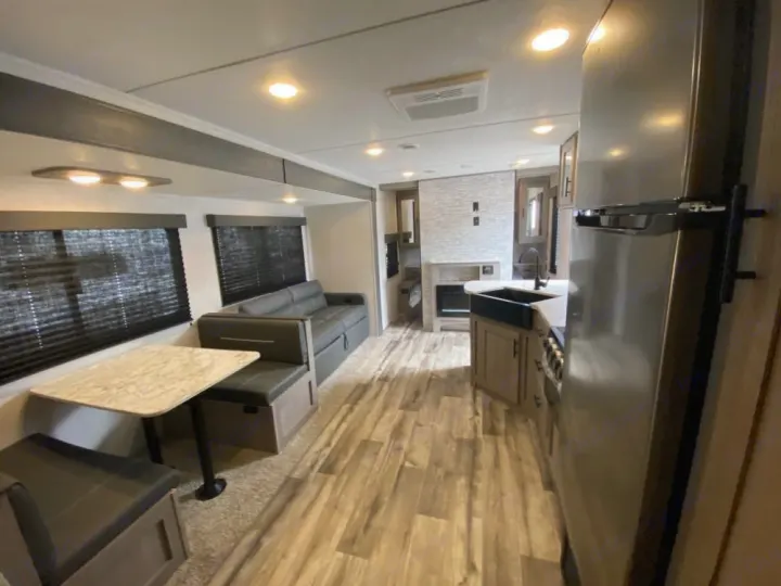 Step inside this modern RV rental! Features a full kitchen, comfortable living area with dinette, and sleek wood-look flooring.. Coleman Lantern 2021