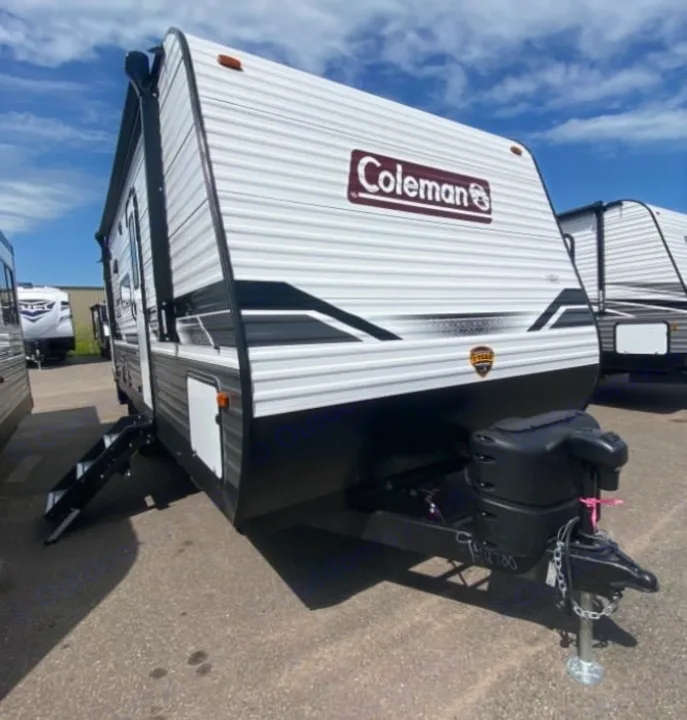 Coleman travel trailer RV rental: a white and black unit with an extended side step and front hitch, parked for viewing.. Coleman Lantern 2021